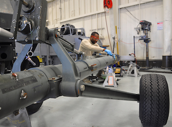 JOINT BASE MCGUIRE-DIX-LAKEHURST, N.J. -- Senior Airman Michael O'Neil, an aerospace ground equipment technician with 514th Maintenance Squadron, repairs a flange on a universal aircraft tow bar here Jan. 20, 2011. The damaged flange was discovered during a scheduled maintenance inspection. The scheduled inspections help to identify and correct potential maintenance problems to ensure the equipment properly operates when used for aircraft maintenance. (U.S. Air Force photo/Tech. Sgt. Shawn J. Jones)